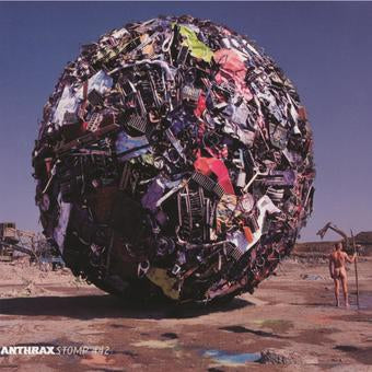 The image depicts the album cover for 'Stomp 442' by Anthrax. It features a collage of various objects including musical instruments, clothing, and other assorted items, all loosely grouped together to form a sort of abstract picture.