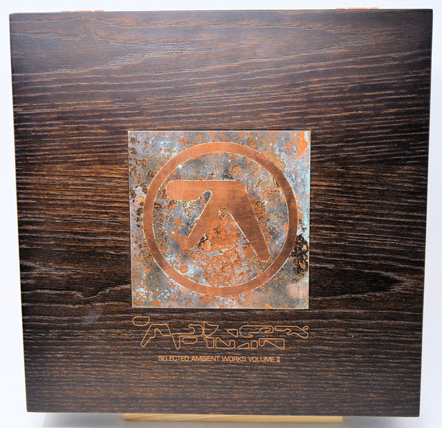 Wooden box with a metal emblem and text on a white background