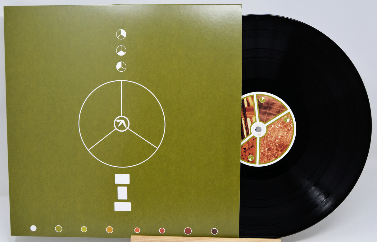 Vinyl record with cover displaying tracklist on a white background