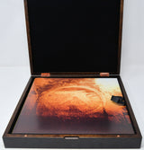 Wooden box with a textured orange and black design on a white background