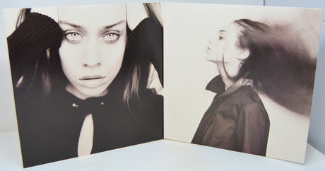 Album cover with black and white portraits of a woman on a light blue background