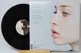 Vinyl record with a portrait on the cover and a white background