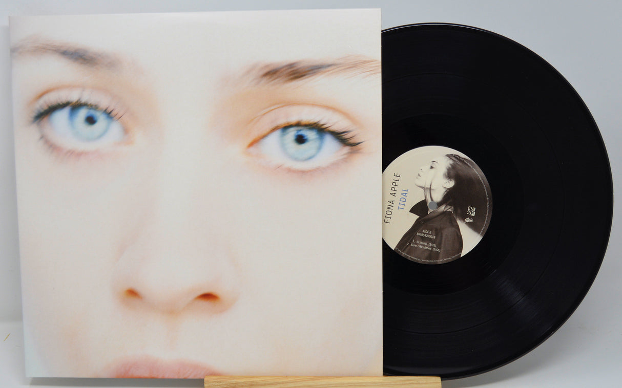 Vinyl record with cover featuring a face and a person's face on the record label.