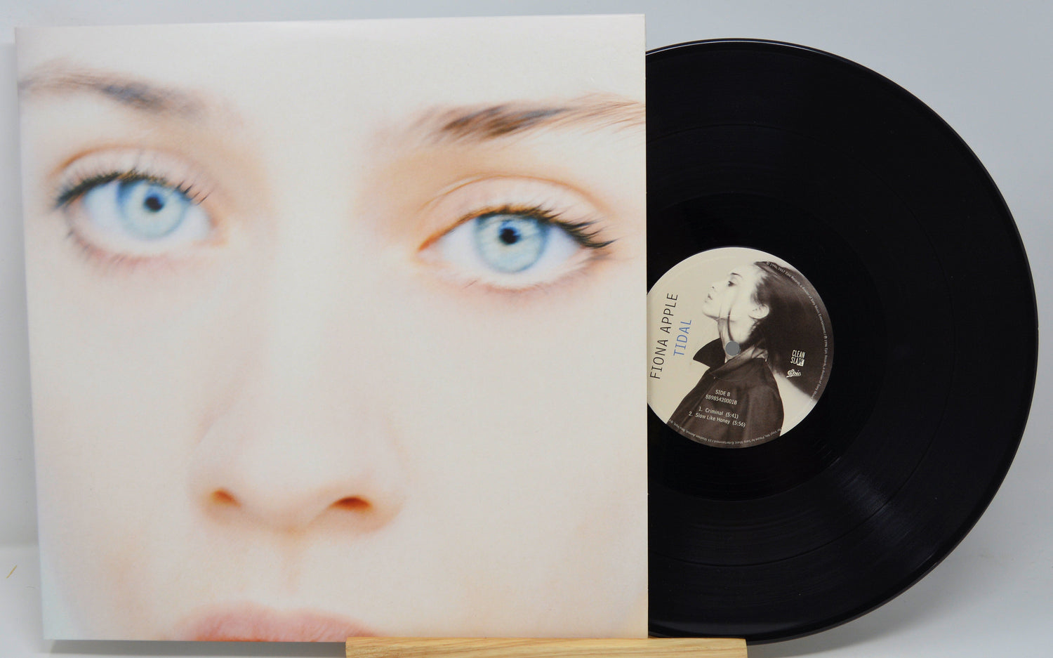 Vinyl record with cover featuring a face and a person's face on the record label.