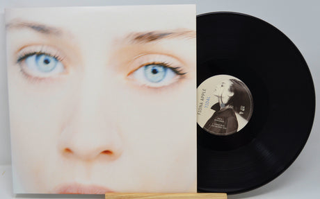 Vinyl record with cover featuring a face and a person's face on the record label.