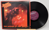 Vinyl record with cover featuring a guitar and red lighting, labeled 'April Wine The Nature of the Beast'.