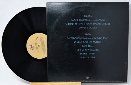 Vinyl record with cover displaying track listings on a white background