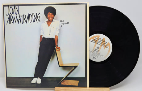 A used vinyl record of Joan Armatrading's album 'Me Myself I' with the artist's photo on the cover, displayed next to the vinyl.