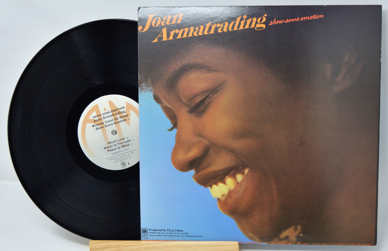 Vinyl record and cover featuring a close-up of a person's face on a blue background