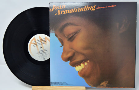 Vinyl record and cover featuring a close-up of a person's face on a blue background