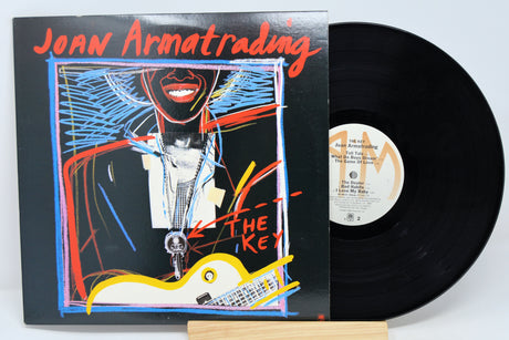 Vinyl record album by Joan Armatrading titled 'The Key' with a colorful cover artwork featuring a stylized image of Joan Armatrading.