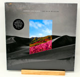 Limited hot pink/black splatter vinyl record album cover for Armor For Sleep - The Rain Museum, with a graphical representation of a desert landscape and pink flowers.