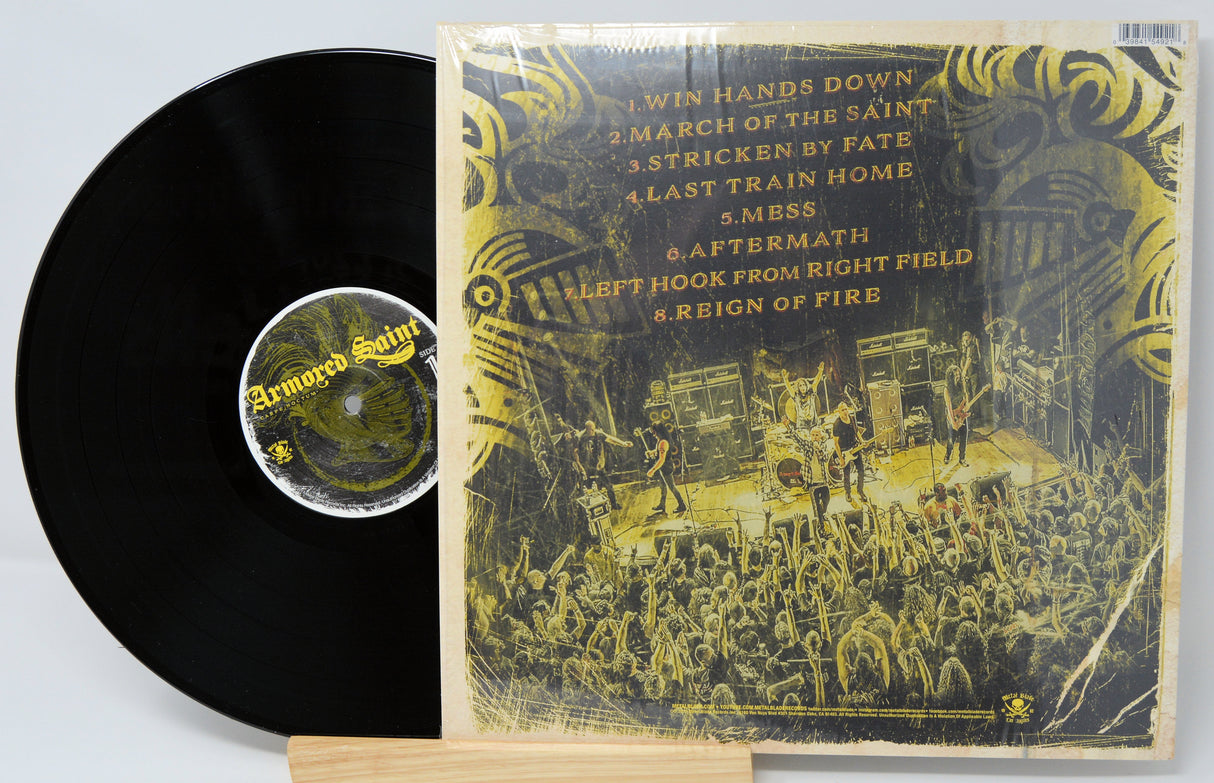 Vinyl record with cover featuring a band performing on stage and album tracklist.