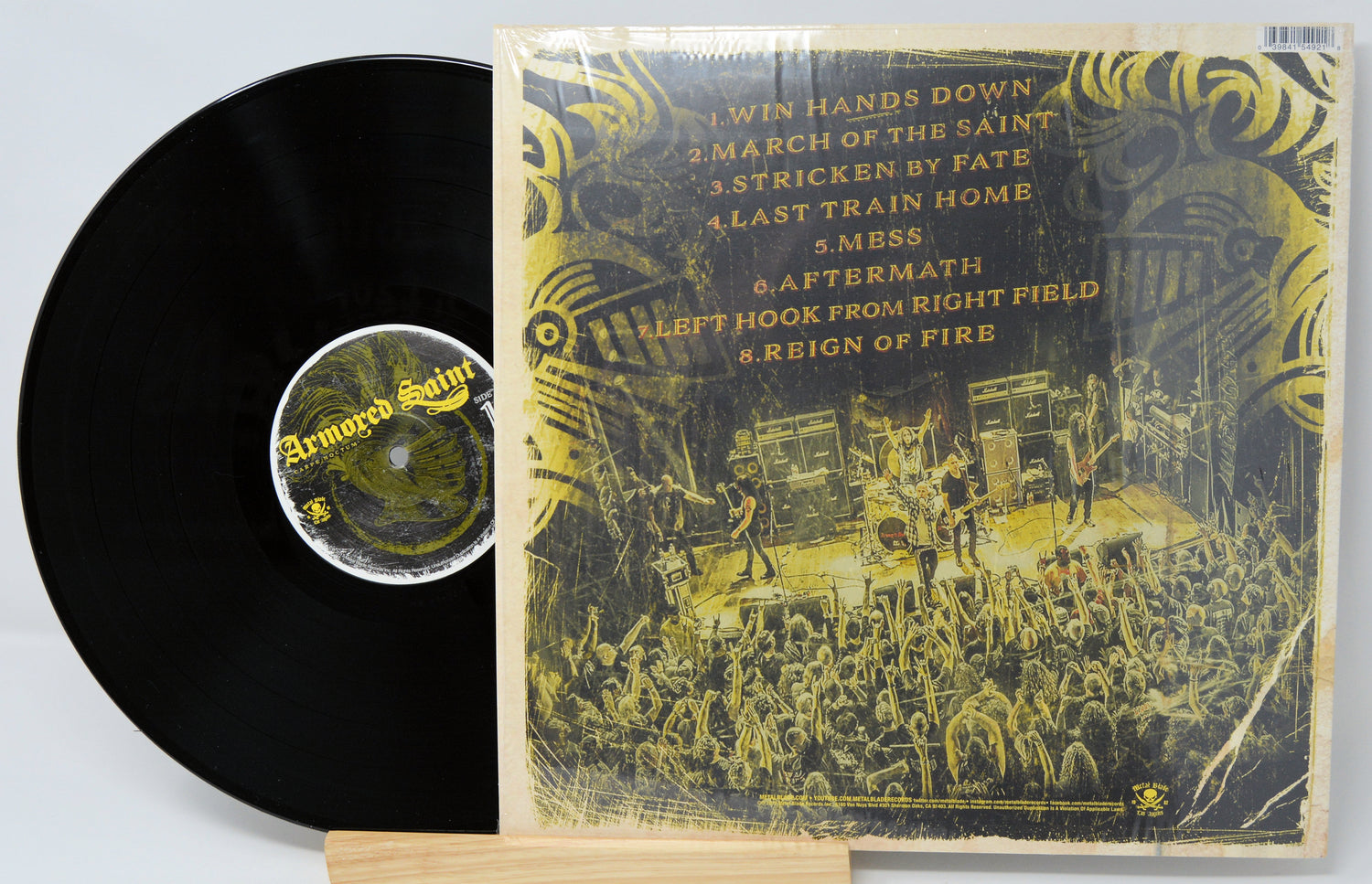 Vinyl record with cover featuring a band performing on stage and album tracklist.