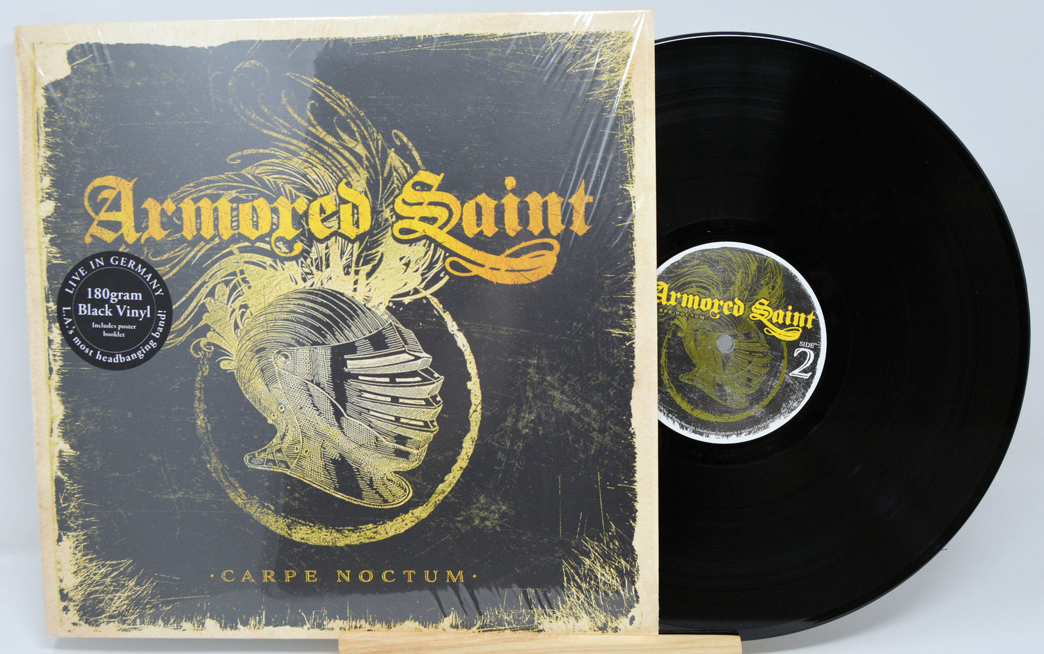 Vinyl record and cover with 'Armored Saint' branding on a light gray background