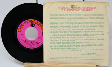 Vinyl record with pink label and record cover featuring text on a white background