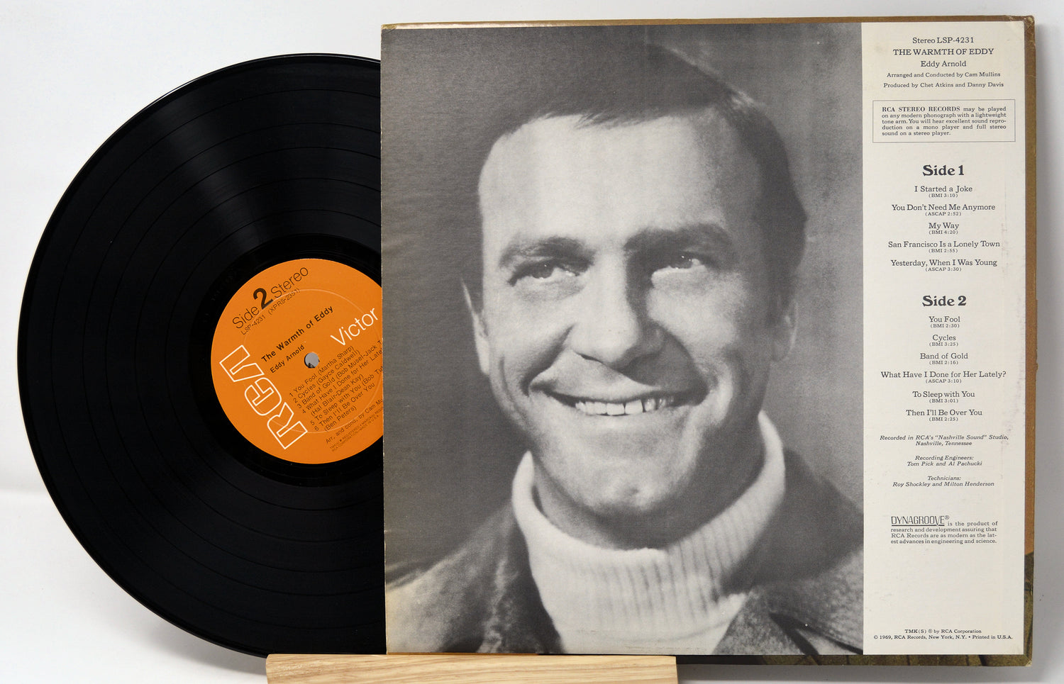 Vinyl record with a portrait of a man on the cover and an orange label.