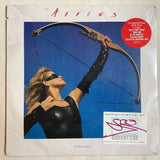 Album cover with a person in black archery gear against a blue sky, featuring the title 'The Arrows' and additional text.