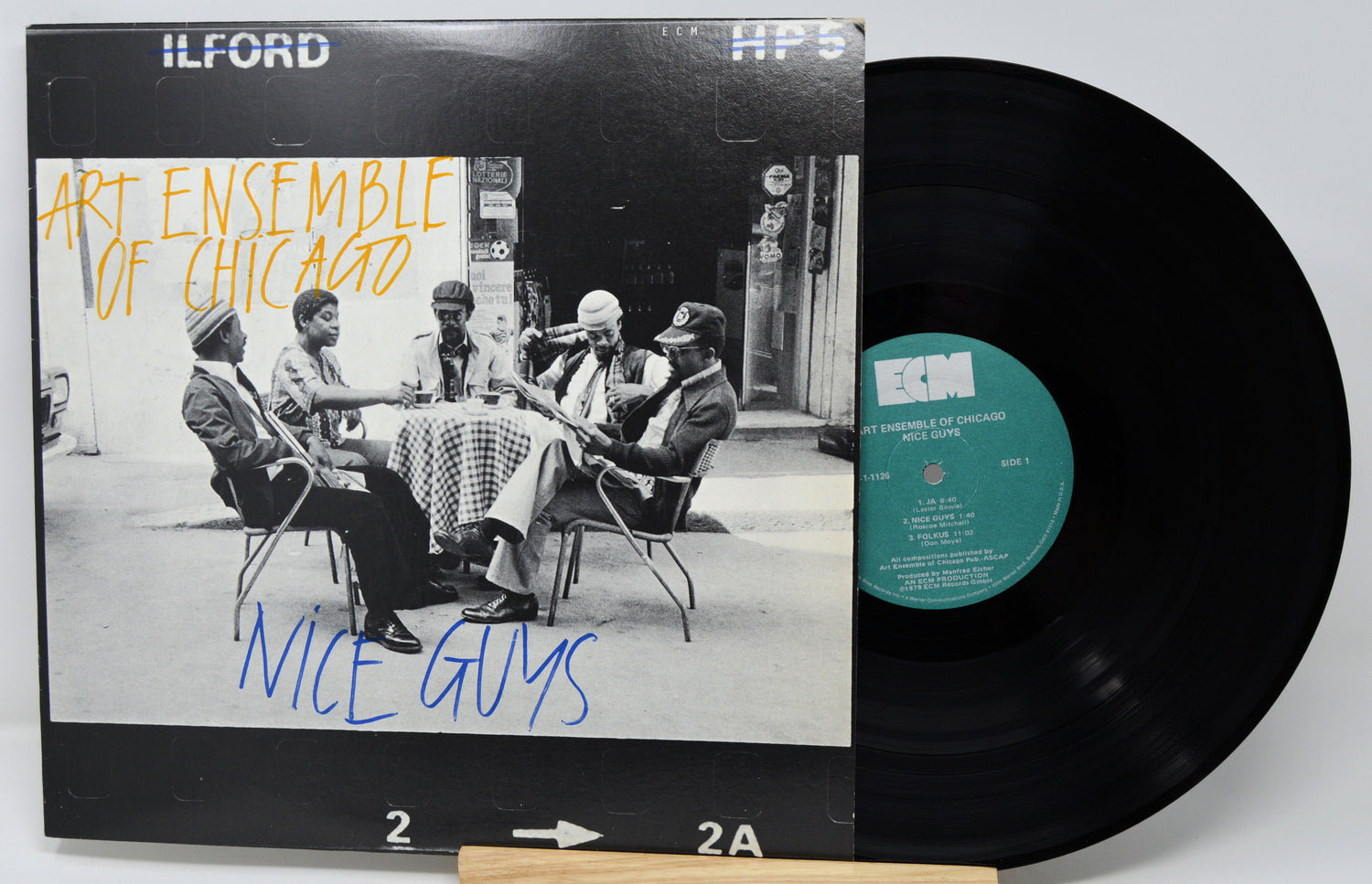 Vinyl record with 'Art Ensemble of Chicago' album cover featuring a group of people around a table.