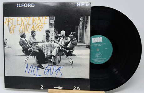 Vinyl record with 'Art Ensemble of Chicago' album cover featuring a group of people around a table.