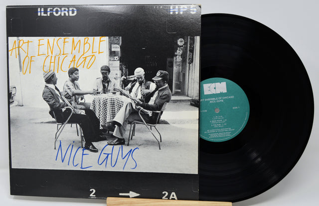 Vinyl record with 'Art Ensemble of Chicago' album cover featuring a group of people around a table.
