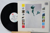Vinyl record with a colorful cover featuring abstract art and text.
