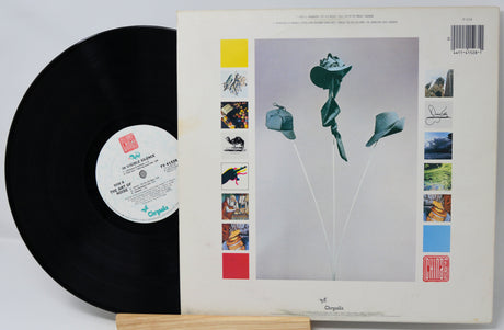 Vinyl record with a colorful cover featuring abstract art and text.