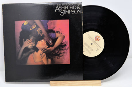 Used vinyl record of Ashford & Simpson with a label showing the title 'Is It Still Good To Ya' and an image of a couple embracing.