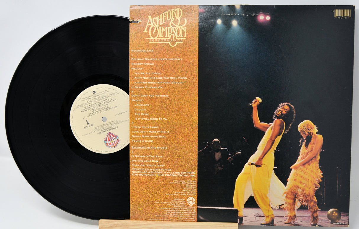 Vinyl record with cover featuring a band on stage