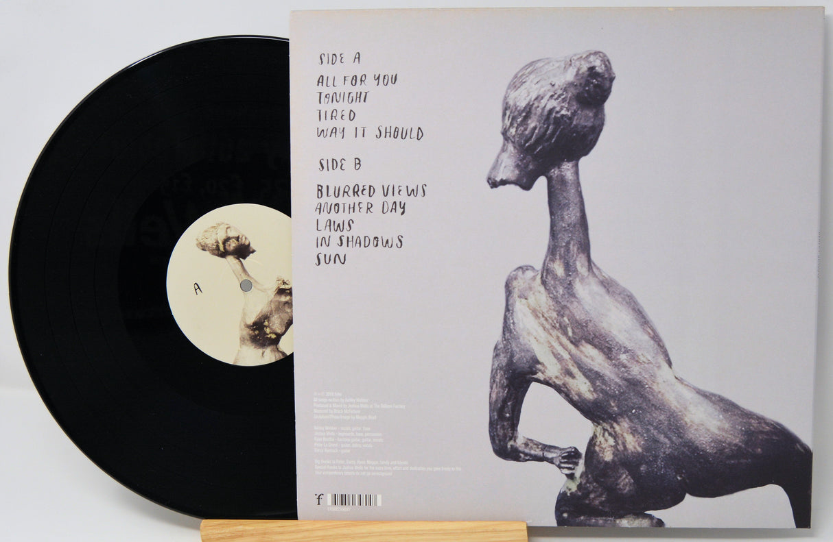 Back cover of Ashley Shadow vinyl record showing hand-written track list and abstract sculpture artwork