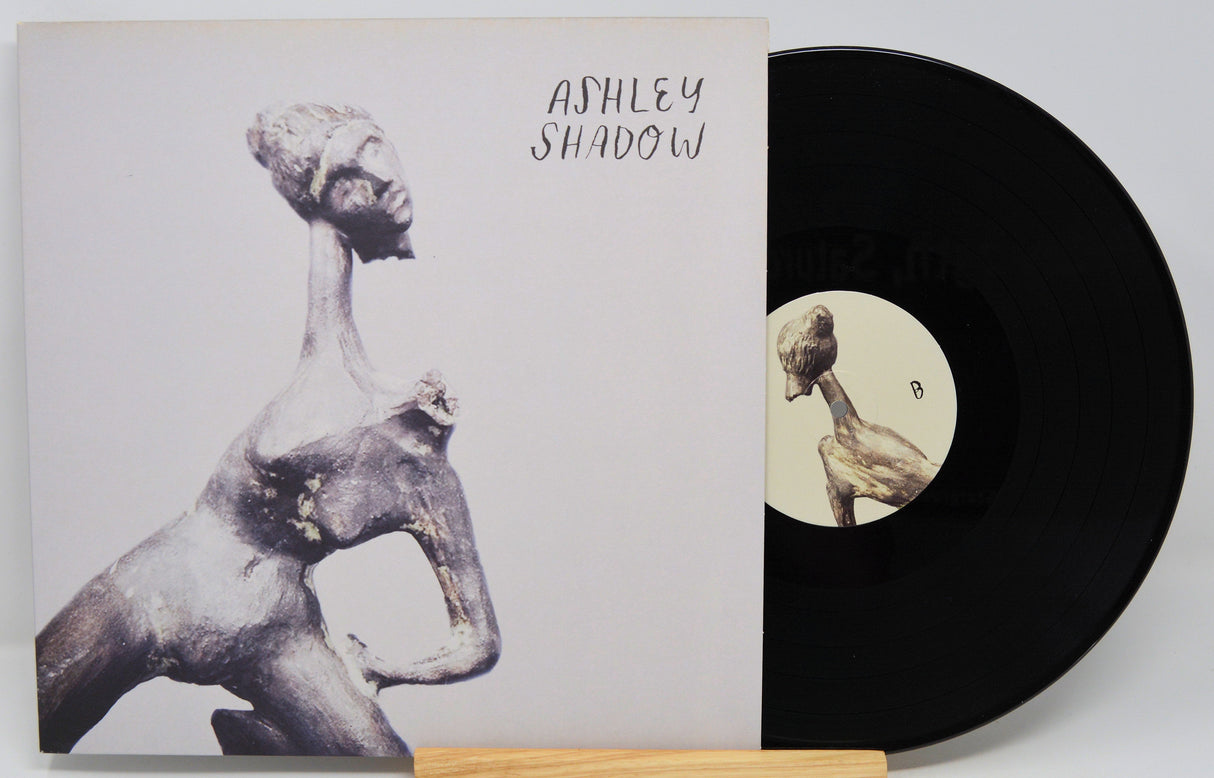 Front cover of Ashley Shadow vinyl LP featuring stylized sculpture and artist's name in handwritten text