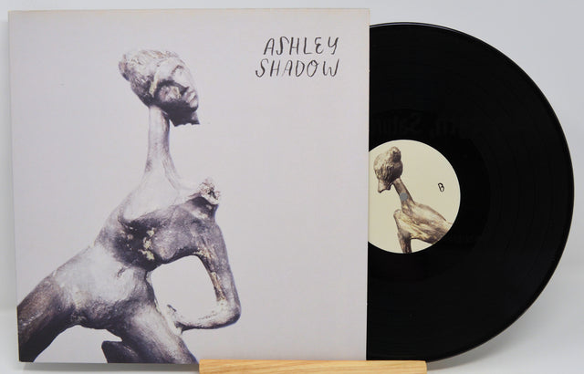 Front cover of Ashley Shadow vinyl LP featuring stylized sculpture and artist's name in handwritten text