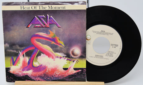 Vinyl record and cover for 'Heat Of The Moment' by Asia on a white background