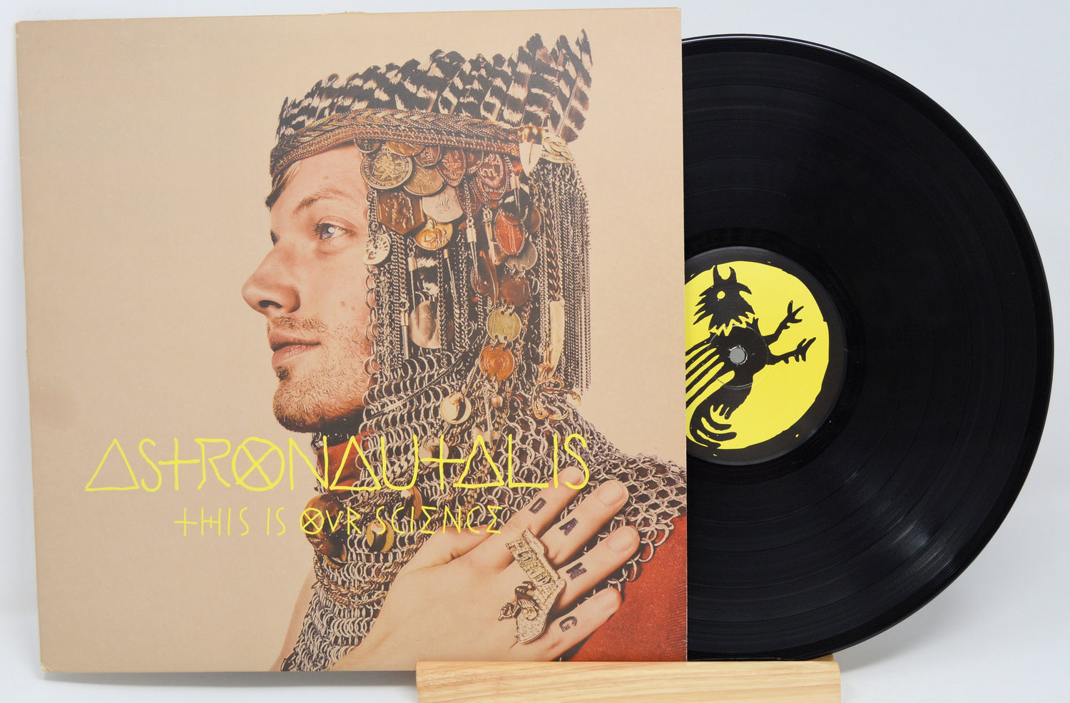 A vinyl record titled 'Astronautalis - This Is Our Science' with a portrait of a man wearing a fantastical, armored costume on the cover.