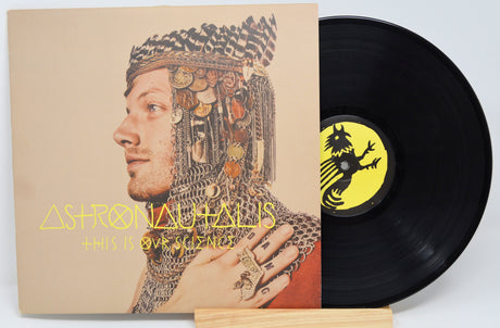 A vinyl record titled 'Astronautalis - This Is Our Science' with a portrait of a man wearing a fantastical, armored costume on the cover.