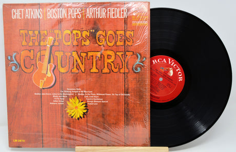 Vinyl record with orange cover featuring text and graphics, on a white background