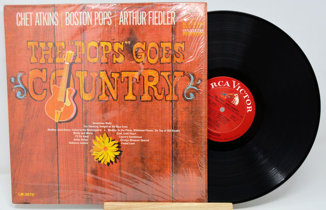 Vinyl record with orange cover featuring text and graphics, on a white background