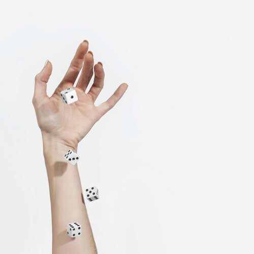 Hand with dice on fingers against a white background