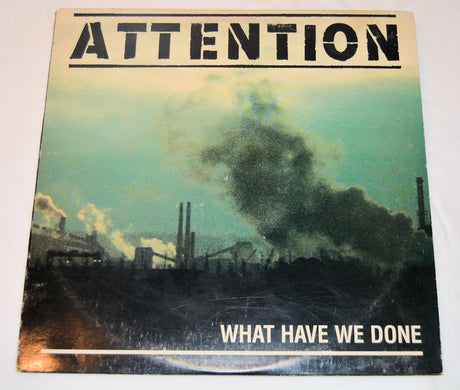 Album cover with industrial scene and 'Attention' text