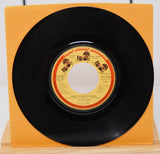 A vinyl record titled 'Sweet Summer Music' by The Spinners, with an orange record label and a black vinyl record.