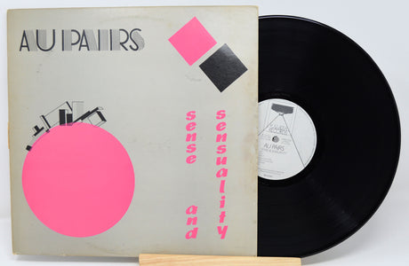 Vinyl record with a cover featuring geometric shapes and text on a white background