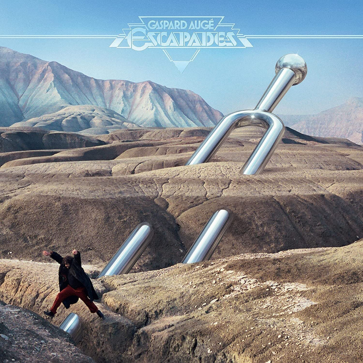 Album cover with a person running on a rocky landscape with large metal pipes and mountains in the background.