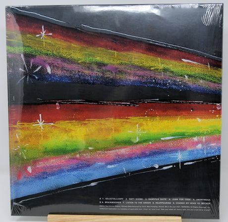 Vinyl record cover with a rainbow design and text on a white background