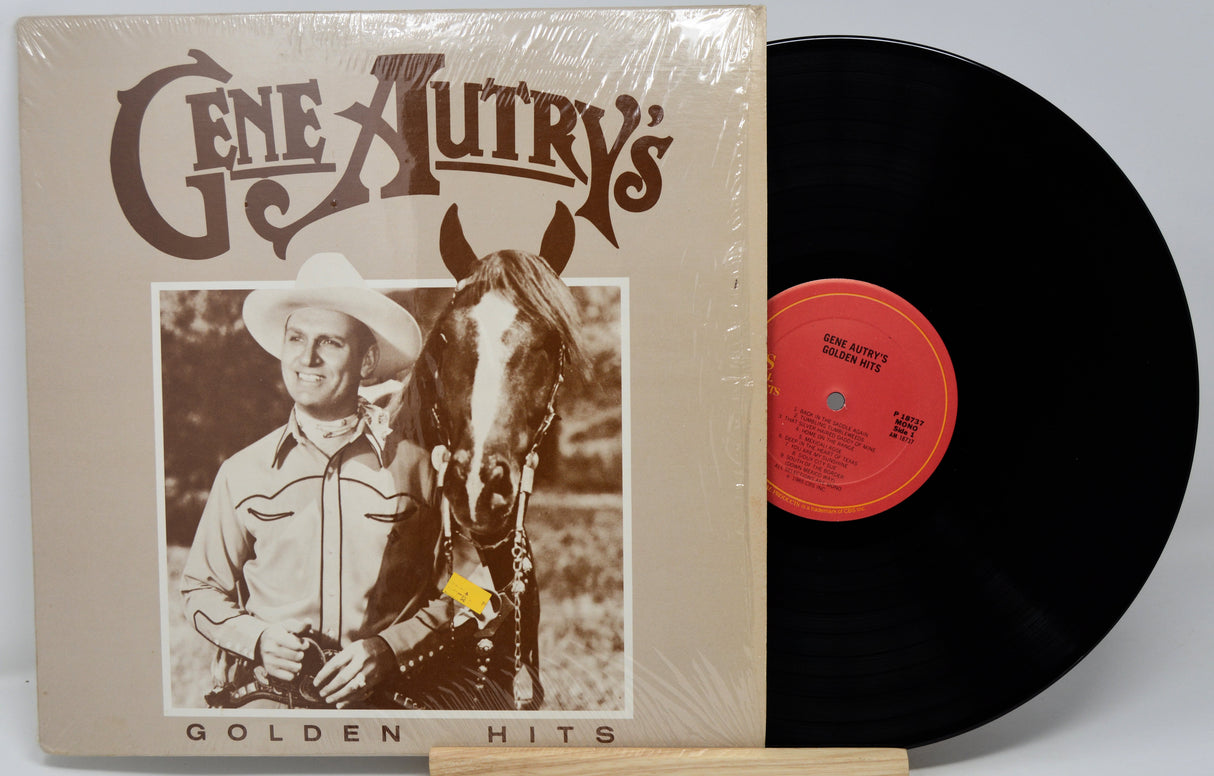 Vinyl record with cover featuring a cowboy and horse, labeled 'Gene Autry's Golden Hits'.