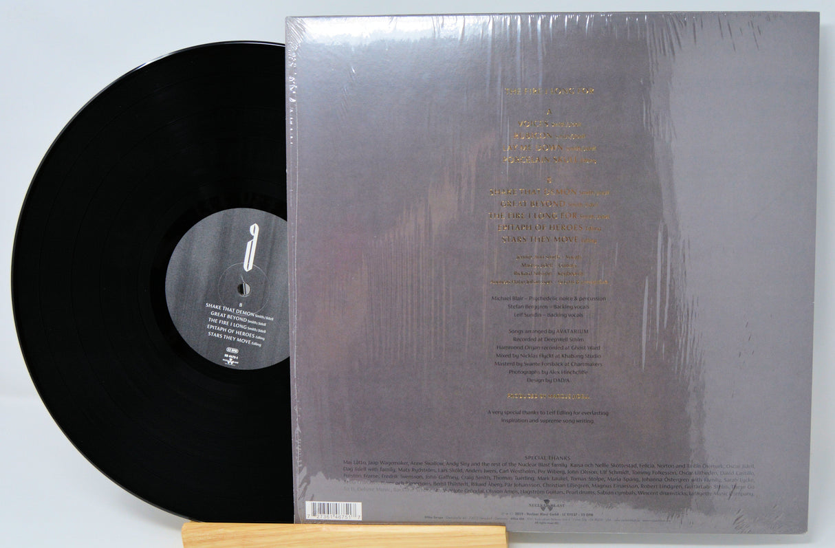 Back cover and black vinyl record of Avatarium's 'The Fire I Long For' LP showing tracklist and credits