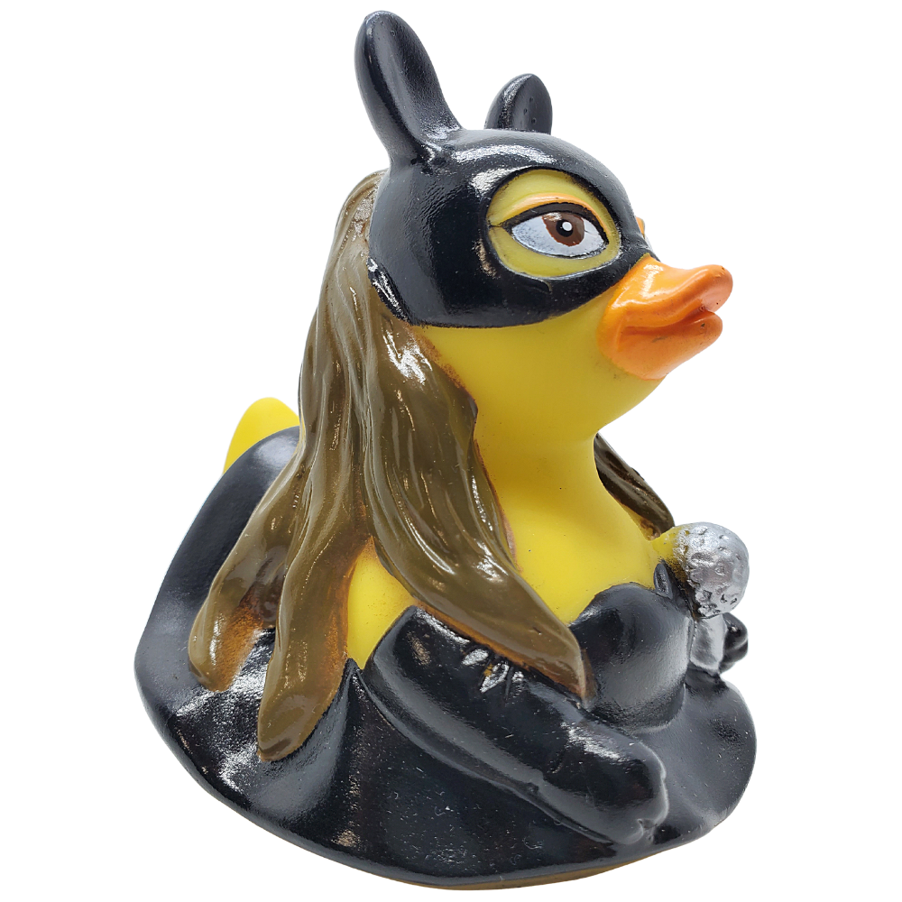 Yellow rubber duck with a superhero mask and cape on a white background