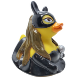 Yellow rubber duck with a superhero mask and cape on a white background