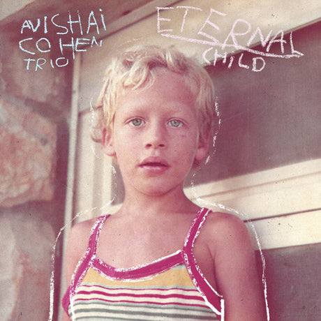 Album cover with a child sitting on a bench, text 'Avishai Cohen Trio Eternal Child'.