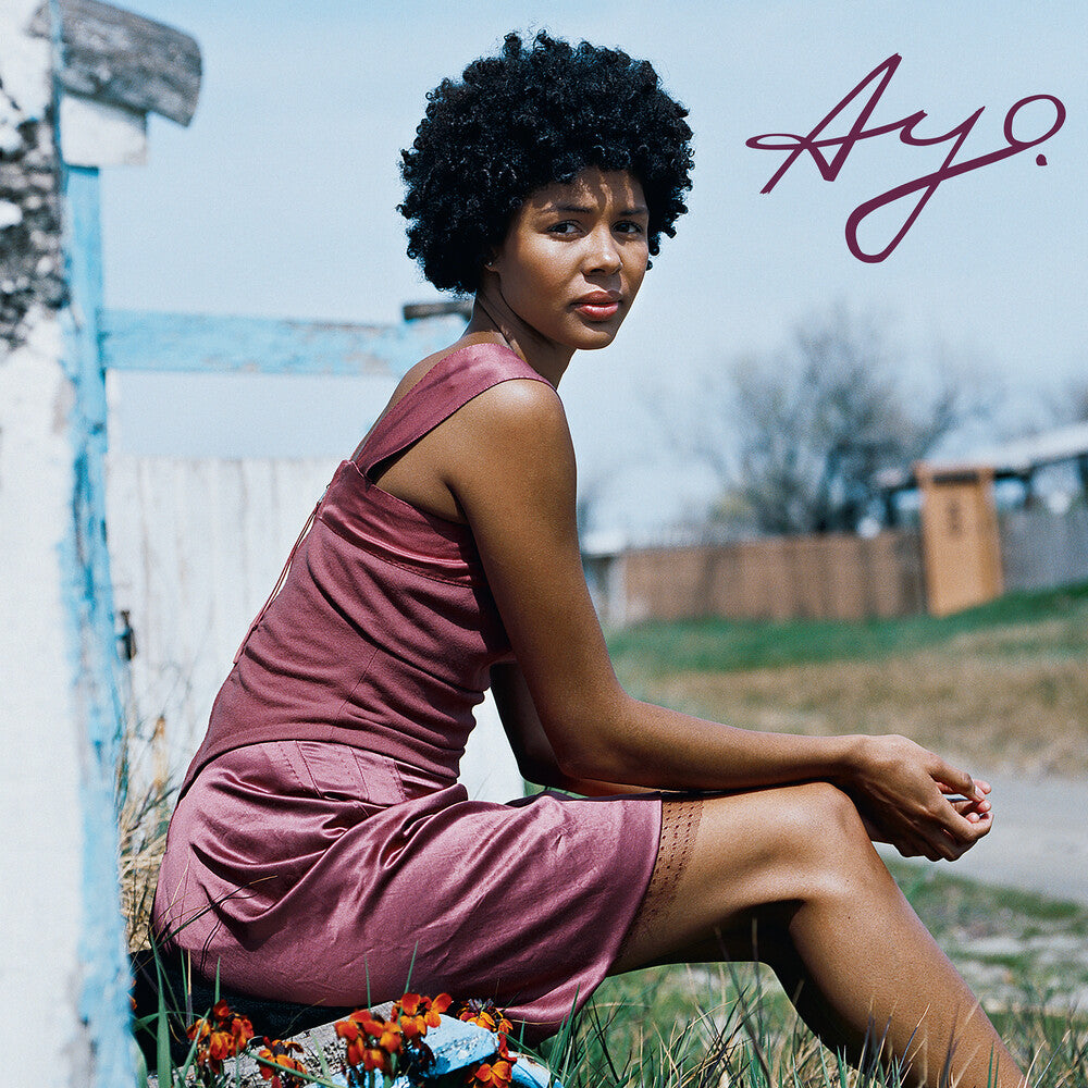 Album cover with a stunning photo of Ayo in a pink dress sitting outdoors, featuring the name 'Ayo' in cursive text.
