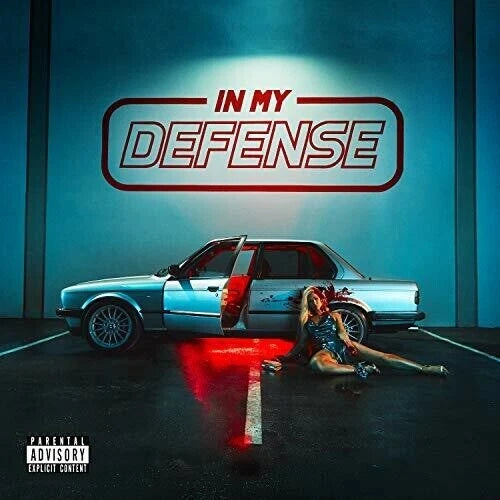 Album cover for 'In My Defense' with a car and person in a dark setting